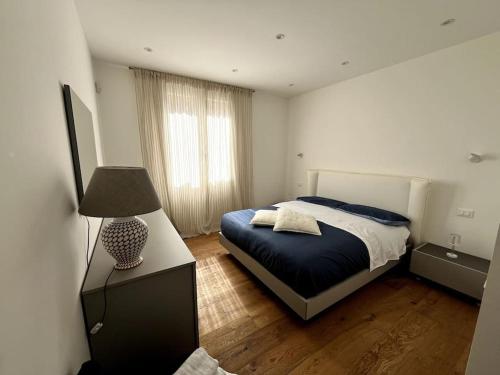 a bedroom with a bed and a lamp in it at Lazio apartment nel centro di Palermo in Palermo