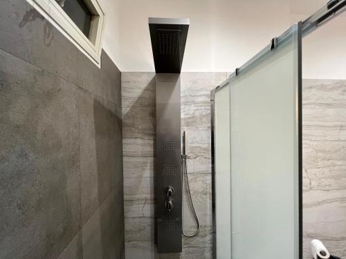 a shower with a glass door in a bathroom at Appartamento in Villa Naomi in Rome