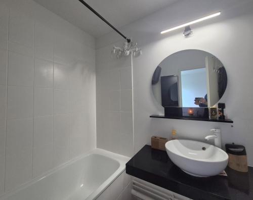 y baño con lavabo, bañera y espejo. en Vélodrome Montigny 2024, en Montigny-le-Bretonneux