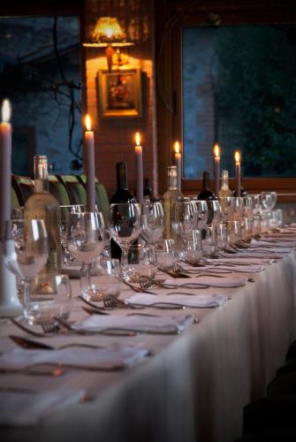 a long table with wine glasses and candles on it at La Casella Antico Feudo di Campagna in Ficulle