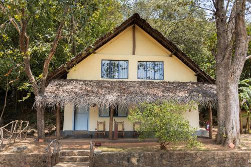 a cottage in the woods with a thatched roof at Amuna Ayurvedic Retreat in Sigiriya