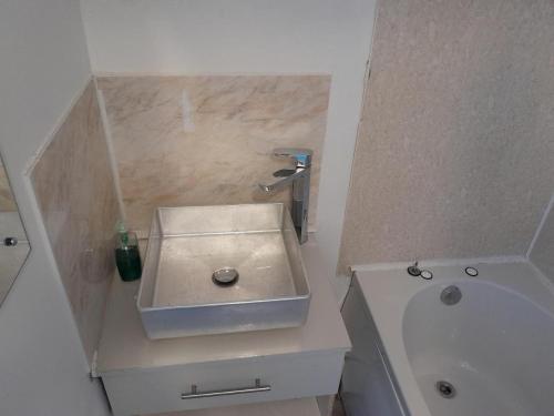 a small bathroom with a sink and a tub at SINGLETON SHORT STAYS R7r5 in Swansea