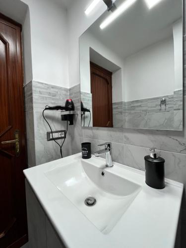 a bathroom with a white sink and a mirror at Casa Leandra in Civitavecchia