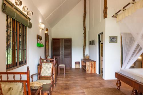 a hallway with chairs and a table in a room at Amuna Ayurveda and Wellness Retreat in Sigiriya