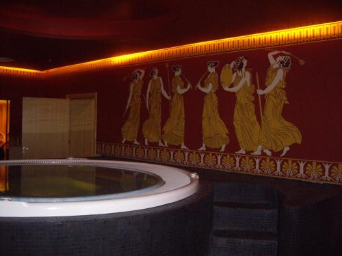 a bathroom with a tub with a painting on the wall at Relaks w Marina Cape 88 in Aheloy