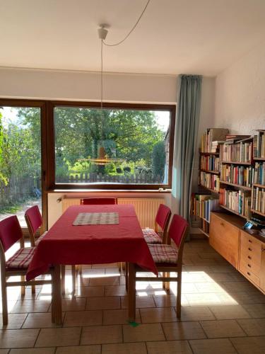 a dining room with a table and chairs and a window at Ferienwohnungen Burgstraße 8 in Blankenheim