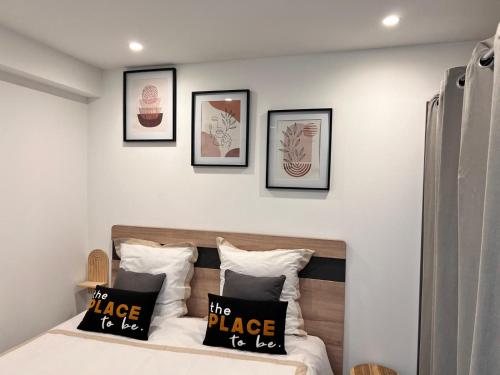 una camera con un letto con quattro quadri sul muro di Bel appartement à 5 minutes de la plage a Cap d'Agde