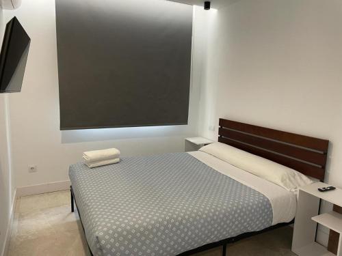 a bedroom with a bed and a large screen at C2 Exclusiva zona Madrid in Madrid