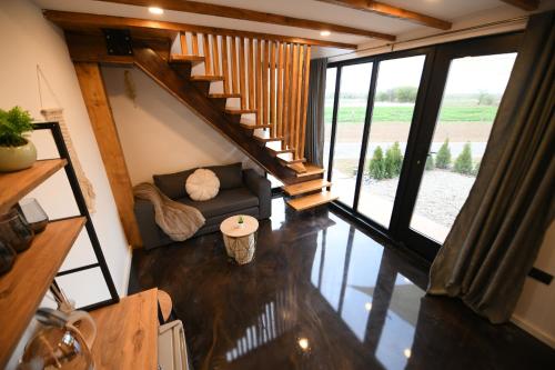 a living room with a couch and a staircase at Natura Bungalow in Ždrelo