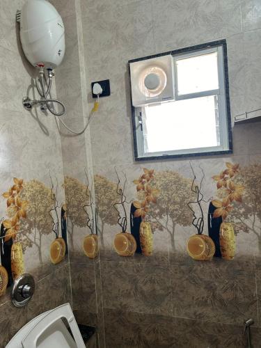 a bathroom with a shower with vases on the wall at Self Check In 1BHK Home fully Equipped Kitchen in Nagpur