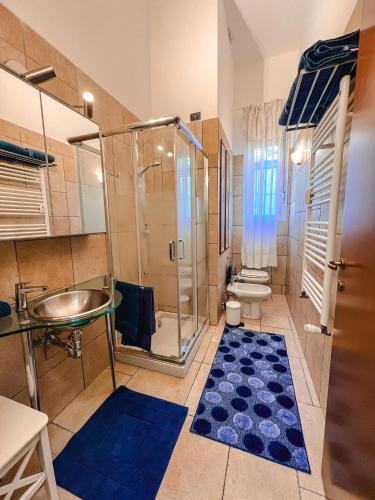 a bathroom with a shower and a sink and a toilet at CasaBlu in Cormano