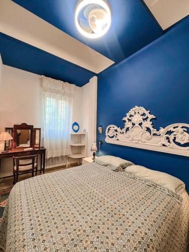 a blue bedroom with a bed and a blue wall at CasaBlu in Cormano