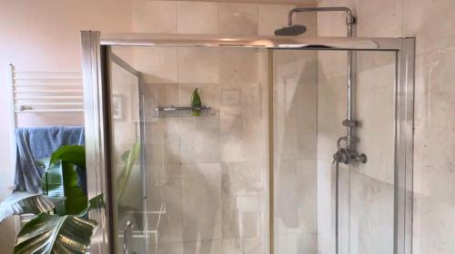 a shower with a glass door in a bathroom at Welholme Avenue Luxury Place in Great Coates