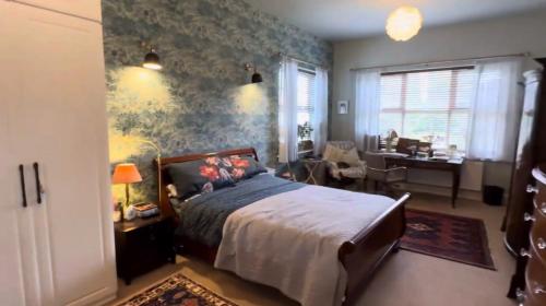 a bedroom with a bed and a desk in a room at Welholme Avenue Luxury Place in Great Coates