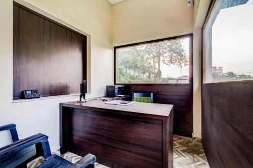 an office with a wooden desk and a window at Super Capital O Gulmohar Marriage Garden in Dhanbād