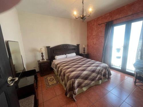 a bedroom with a bed and a large window at Paseo del Obispo Apartamento A3 in Antigua Guatemala