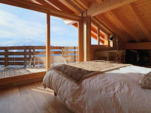 a bedroom with a bed and a large window at Appartement Montvalezan-La Rosière, 5 pièces, 10 personnes - FR-1-398-549 in La Rosière