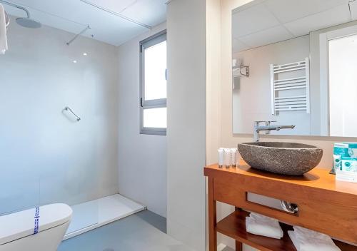 a bathroom with a sink and a toilet at Flamingo Beach Resort - Adults Recommended in Benidorm