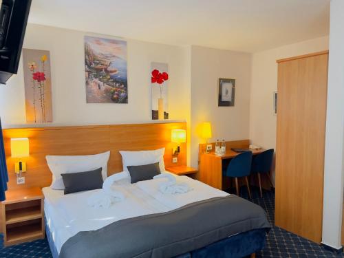 a hotel room with a large bed and a desk at Elbbrücken Hotel in Hamburg