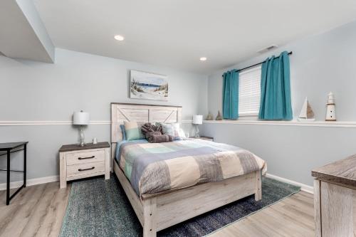 a bedroom with a bed and a window with blue curtains at Neptune By The Water in Annapolis