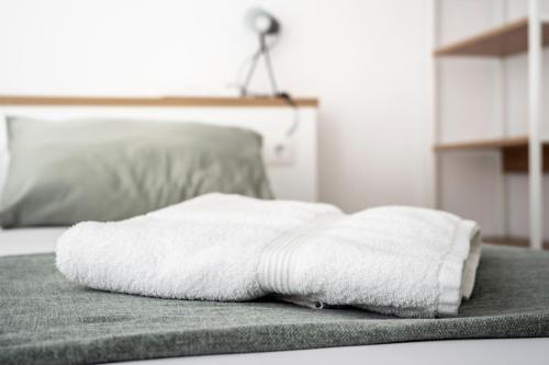 a pile of towels sitting on top of a bed at CALMA Apartments in Benidorm