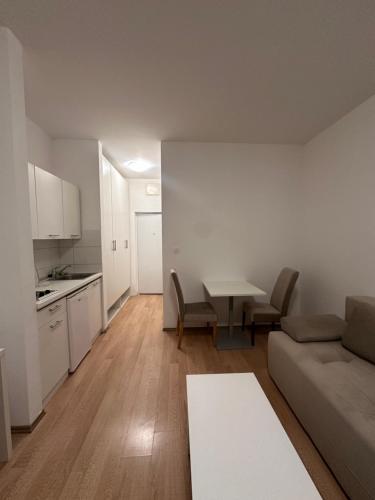 a living room with a couch and a table at Studio Apartment L in Mostar