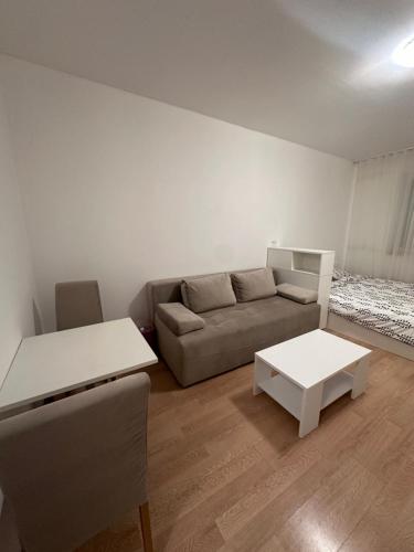 a living room with a couch and a table at Studio Apartment L in Mostar