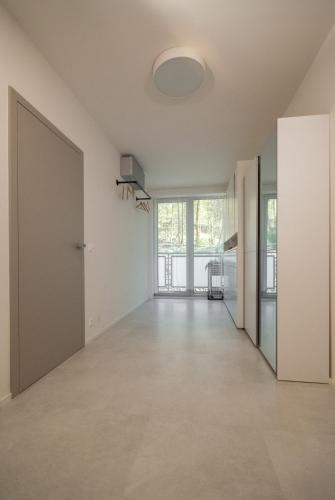 an empty room with white walls and a large door at Apartmán víla Amálka in Janov nad Nisou