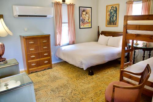 a bedroom with a bed and a dresser at Yosemite Bug Rustic Mountain Resort in Midpines