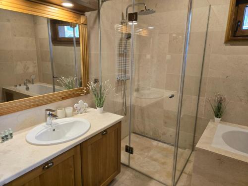 een badkamer met een wastafel en een douche bij Boutique Holiday Pirin Golf in Razlog