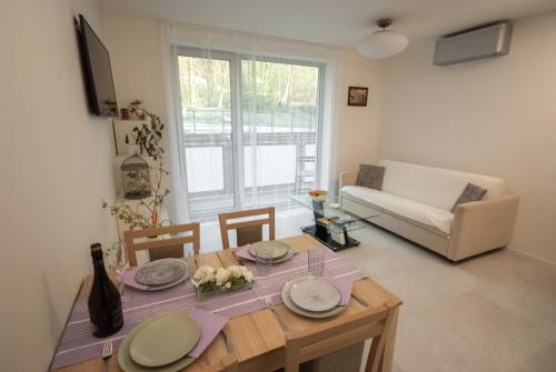 a living room with a table and a couch at Apartmán víla Amálka in Janov nad Nisou