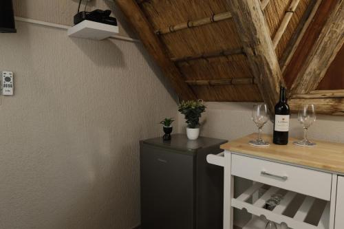 a kitchen with a refrigerator and wine glasses at Shingalana Guest Lodge in Hazyview