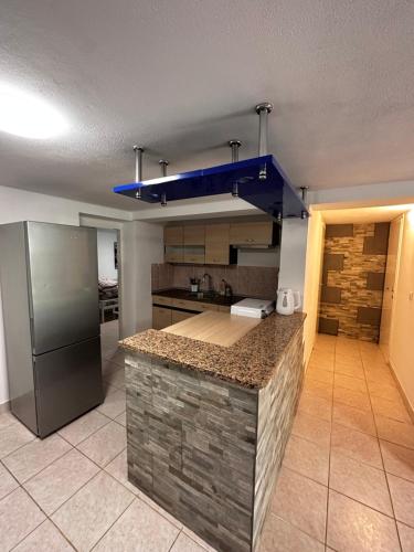 a kitchen with a refrigerator and a counter top at Apartment in Poreč, Croatia in Nova Vas