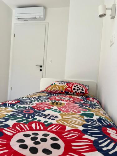 a bedroom with a bed with a colorful comforter at Sun Fun APT in Omiš