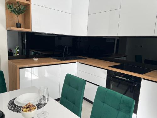 a kitchen with a table with a plate of fruit on it at Sun Fun APT in Omiš