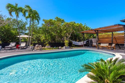 a swimming pool in the backyard of a house at Casa Olan - Luxury Family Oasis 3BR North Miami Beach Villa with Saltwater Pool & Canal Views in Miami
