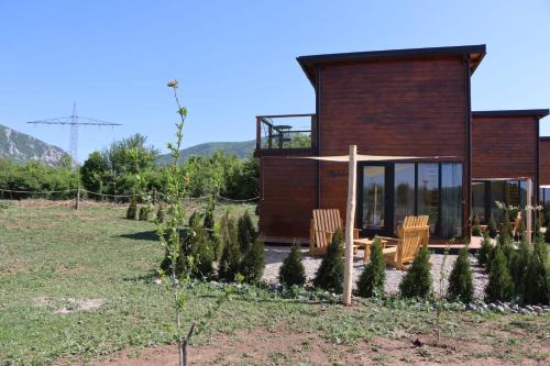 a house with a bunch of trees in front of it at Natura Bungalow in Ždrelo