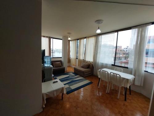 a living room with a couch and a table at Departamentos de la Costa in Machala