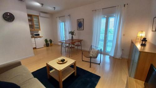 a living room with a couch and a table at Apartments Daria in Krk