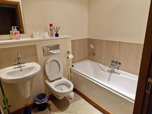 a bathroom with a sink and a toilet and a bath tub at Impeccable 1-Bed Apartment in Purfleet in Purfleet