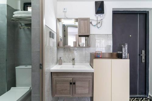 a bathroom with a sink and a toilet and a tub at High Rise Haven: Panoramic Views in Nairobi