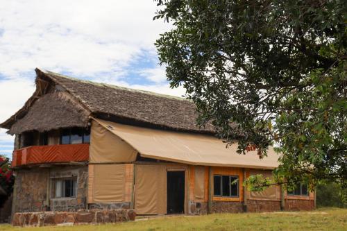 an old house with a gambrel roof at Orng'atuny Mara King Camp in Masai Mara