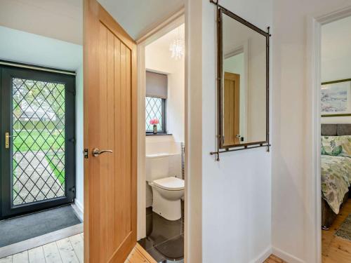 a bathroom with a toilet and a mirror at 3 Bed in West Mersea 94316 in West Mersea