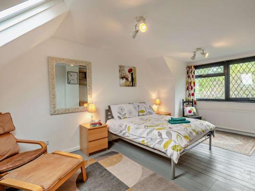 a bedroom with a bed and a chair at 3 Bed in West Mersea 94316 in West Mersea