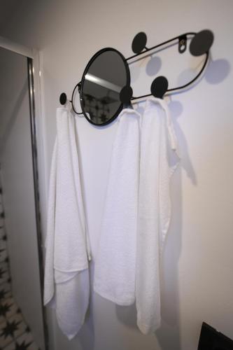a mirror hanging on a wall with towels at Natura Bungalow in Ždrelo
