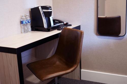 a chair sitting at a desk with a coffee maker at Leon Hotel LES in New York