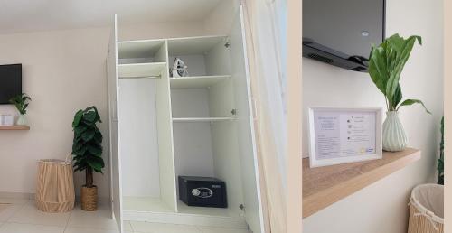 a closet with a door open with a plant at Bubali Residence in Palm-Eagle Beach