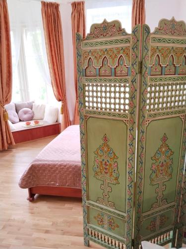 a green bedroom with a bed and a couch at Leier apartments in Piešťany