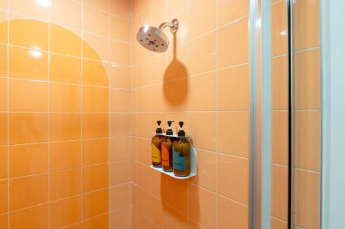 a bathroom with a shower with two bottles at The Gallatin in Nashville