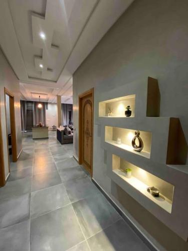a hallway with shelves on the wall in a building at Ezz’Dar HOME II in Asilah